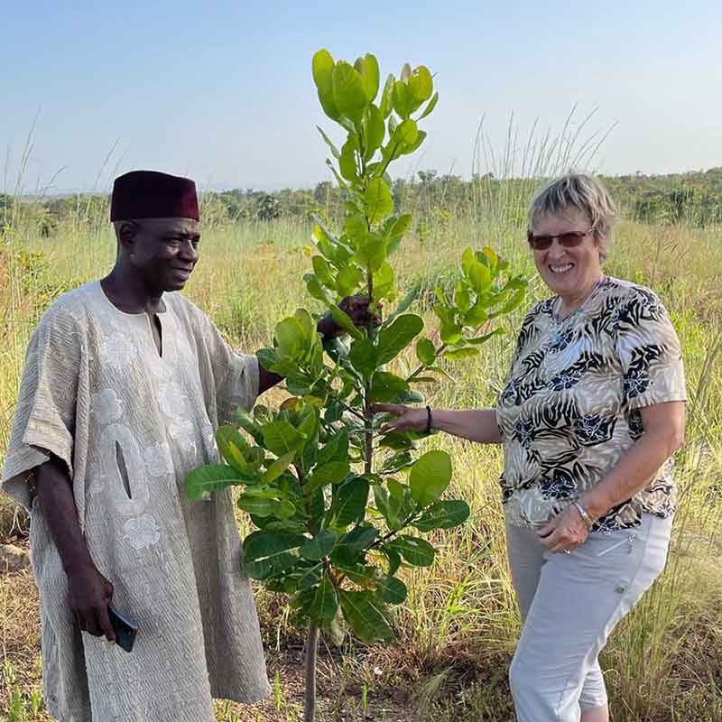 Margret Kopp zusammen mit dem Dorfchef aus Djambe bei einem Cashew-Baum