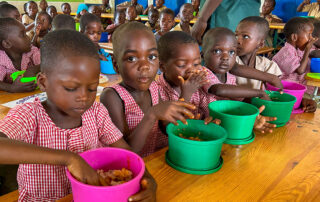Kinder essen in der Kantine in Togo